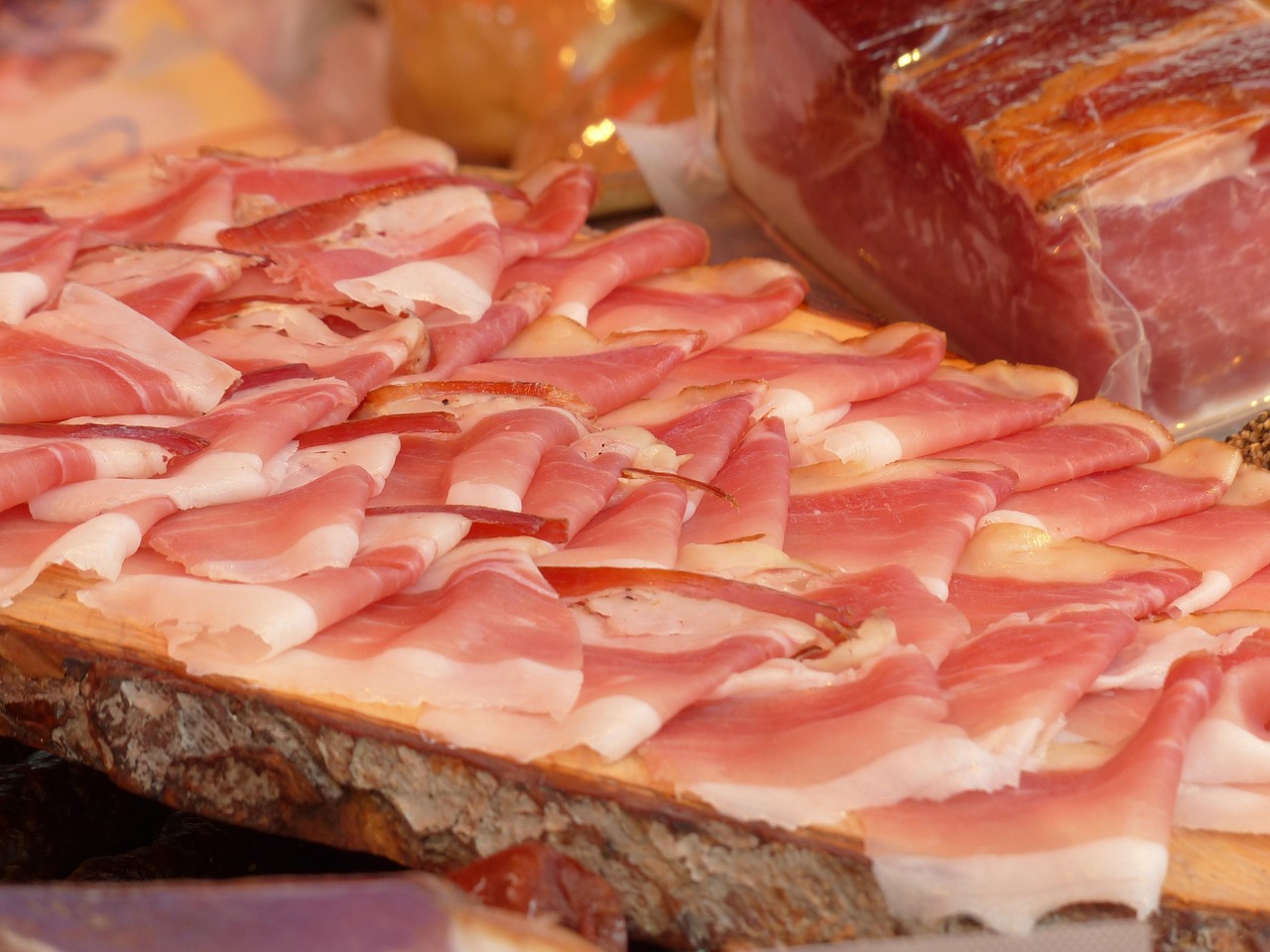 Immagine di un piatto con prosciutto crudo, evidenziando i rischi per la salute.